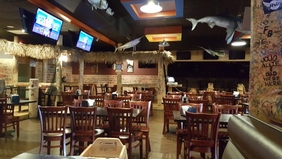 Busy dining room with beer and seafood orders.